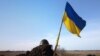 A Ukrainian flag and a helmet of a soldier are pictured at checkpoint, as Russia's invasion of Ukraine continues, in Mykolaiv.