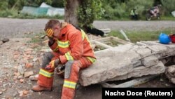 Харьков облусунун Чугуев шаарында орус армиясынын соккусунан жабыркагандарга жардам берип жаткан куткаруучу. 