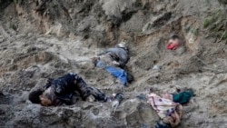 Ukraine -- Four bodies lie in a mass grave, including the village mayor Olha Sukhenko and her family, in Motyzhyn close to Kyiv, Ukraine, Monday, April 4, 2022