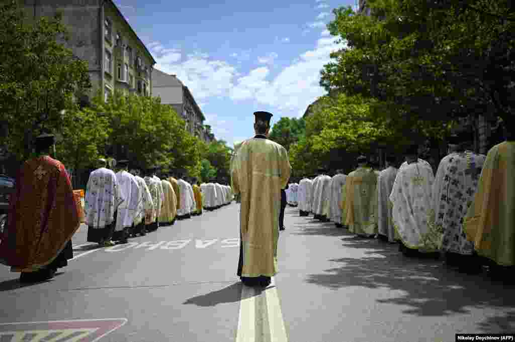 A procession of priests dressed in their finery follow the holy relic through the Bulgarian capital on May 23.&nbsp;