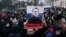 A protester holds up an image of Aleksei Navalny saying "Free Navalny!" at a march in support of the jailed opposition leader in downtown Moscow in January 2021.