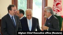 U.S. special representative for Afghanistan Zalmay Khalilzad (center), U.S. Ambassador John Bass and Afghanistan Chief Executive Abdullah Abdullah talk ahead of a meeting in Kabul on October 27.