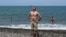A Russian tourist soaks up the sun on a beach in Batumi amid reports of danger for Russians in Georgia. 