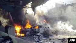 Vehicles burn following an explosion in the town of Darkush, in Syria's Idlib Province, on October 14.