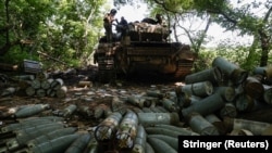 Shells are seen around a tank at a position of Ukrainian service members in the Donetsk region on June 11.