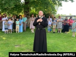 Отець Леонід спілкується з людьми, які втратили рідних на війні