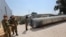 Members of the Israeli military stand next to an Iranian ballistic missile which fell in Israel on the weekend, during a media tour at the Julis military base near the southern Israeli city of Kiryat Malachi on April 16, 2024.