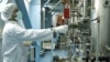 A worker adjusts machinery at a uranium-conversion plant in Isfahan, Iran. 