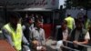 Afghan health workers transport a wounded man to a hospital after a bomb explosion targeted a police station in a residential area of Kabul on August 7.