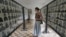 A foreign tourist pauses to look at portraits of those killed by Pol Pot and his regime at Touel Sleng prision, in Phnom Penh, Cambodia.