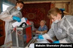 RUSSIA -- A woman casts her vote in her house on the first day of a three-day long parliamentary elections in the village of Tarbagatay, in the Republic of Buryatia, September 17, 2021