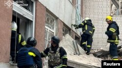 Salvatorii ucraineni examinează pagubele provocate de rachetele rusești la Cernihiv, în dimineața zilei de 17 aprilie. 