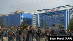 AFGHANISTAN -- Afghan policemen keep watch at the site of a sucide attack outside a wedding hall in Kabul, November 16, 2017