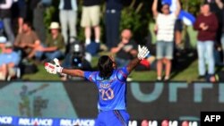 Afghan batsman Shapoor Zadran celebrates after hitting the winning runs to defeat Scotland in their 2015 Cricket World Cup match.