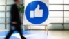 Një punëtor i Facebook-ut kalon pranë shenjës “like” të vendosur në selinë e kësaj kompanie në Kaliforni. 23 tetor, 2019. 