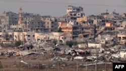 Slika snimljena sa južne granice Izraela sa Pojasom Gaze 11. decembra 2024. prikazuje uništene zgrade unutar palestinske teritorije