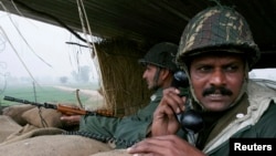 Indian Border Security Force soldiers keep watch from a bunker near the fenced border with Pakistan. (file photo)