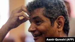 FILE: Mohammad Hanif, the former fighter pilot turned journalist, reacts as he speaks during an interview with AFP in Islamabad in September 2019.