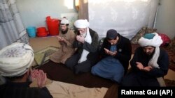 FILE: Taliban prisoners pray inside the Pul-e-Charkhi jail in Kabul in December 2019.