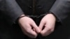 The handcuffed hands of Russian lawmaker Rauf Arashukov who was arrested this week on two counts of murder. 