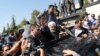 Rohani waving to supporters after arriving in Tehran last month following his ice-breaking trip to New York.