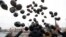 Russian opposition activists and human rights defenders release black balloons in front of the Kremlin to mark the sixth anniversary of the death in prison of lawyer Sergei Magnitsky in Moscow on November 16, 2015.