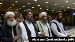 FILE: Mullah Abdul Ghani Baradar, the Taliban group's top political leader, second from left, arrives with other members of the Taliban delegation for talks in Moscow in May.