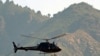 A Pakistani Frontier Corps helicopter flies over monitors the Taliban in the Umar Abad area outside the Buner district. Some 50,000 residents have fled the area due to recent fighting.