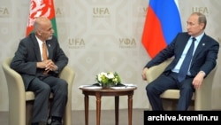 FILE: Russian President Vladimir Putin (R) with Afghan President Ashraf Ghani of Afghanistan, July 2015.