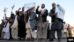 On October 24 Afghans, including religious clerics, hold placards and shout slogans during a protest in Kabul against an allegedly blasphemous article which appeared in the Afghanistan Express newspaper.