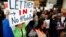 Demonstrators hold welcome signs for immigrants at San Francisco's international airport on January 28 as anger mounted over President Donald Trump's executive order. 