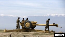 FILE: Afghan National Army (ANA) soldiers clean an artillery at a hilltop in Baghlan Province.