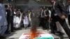 Lawyers burn a banner with a picture of India's national flag and Prime Minister Narendra Modi during an anti-India protest in Multan, Pakistan, on April 28.