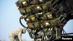 A U.S. soldier inspects a Patriot missile-defense battery during joint exercises near Warsaw in 2015.