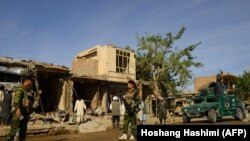 Afghan soldiers at the site of a bomb explosion in Herat province in April 10.