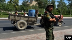 Қытай полиция Шыңжаңдағы ұйғырлар тұратын Лухун кентіне кіретін жолда өткен-кеткенді бақылап тұр. 28 маусым 2013 жыл (Көрнекі сурет)