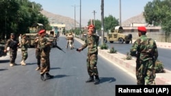 Afghan security forces arrive at the site of an explosion in Kabul on July 1.