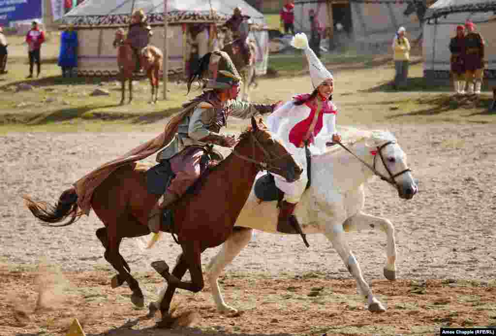 A traditional game that earned hollers from the crowd saw a male rider gallop after a young woman, stretching for a kiss. Only a handful of the men managed the risky peck before the young women turned the tables and thundered after the men with whips in hand.