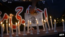 An impromptu shrine in the Pakistani city of Lahore to a news cameraman killed in a suicide bombing in 2016. 