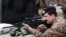 FILE: Raheel Sharif trying a rifle during his visit to the Pakistan Ordnance Factories in April 2015.