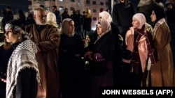 În imagine, membri ai familiilor și prieteni ai unor prizoniei palestinieni din închisori israeliene așteaptă eliberarea acestora, duminică, lângă orașul Ramallah, din Cisiordania, ca parte a acordului de încetare a focului din Fâșia Gaza.