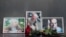 Photographs of journalists Orkhan Dzhemal (right), Kirill Radchenko (center) and Aleksandr Rastorguyev are seen at a small memorial to the slain jounalists outside the Central House of Journalists in Moscow.