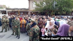 People waiting for the release of prisoners outside a prison in Dushanbe on October 28.
