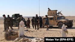 Afghan security officials patrol in Helmand on March 3.