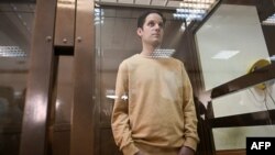 U.S. journalist Evan Gershkovich, arrested on espionage charges, stands inside a defendants' cage before a previous hearing to consider an appeal at the Moscow City Court on September 19, 2023.