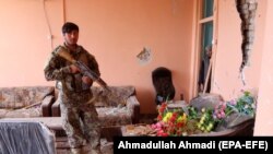 An Afghan Army soldier inspects the scene of a truck bomb blast that targeted the military courts in Gardez, the provincial capital of Paktia province on May 14.