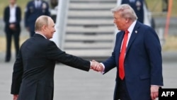 Президент США Дональд Трамп (праворуч) тисне руку лідеру РФ Володимиру Путіну перед зустріччю на об’єднаній базі Ельмендорф–Річардсон в Анкориджі, Аляска, 15 серпня 2025 року