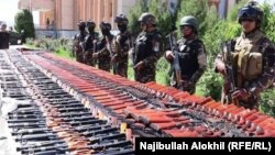 Two commanders were reportedly among the 11 dead militants, and weapons and ammunition were also seized in the raid. Pictured: a weapons raid in Paktia Province in May
