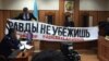 Надпись: «От правды не убежишь» – демонстрируют в зале суда, где рассматривают дело в отношении развернувших баннер активистов. Алматы, 21 апреля 2019 года.
