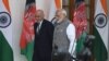 Indian Prime Minister Narendra Modi (R) and Afghan President Mohammad Ashraf Ghani walk together before a meeting in New Delhi on October 24.